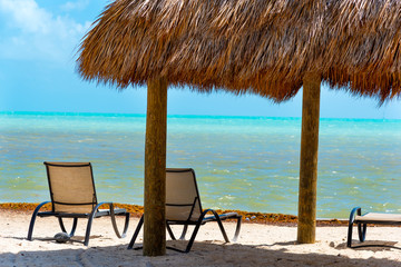 Beach chairs and canopy by the sea in Florida Keys
