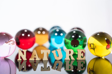 Abstract composition with transparent glass balls and wooden letters.