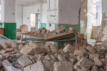 Broken school desk in abandoned textile factory, that is bankrupted and demolished