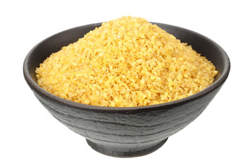 dry bulgur wheat in bowl isolated on white background