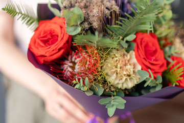 Small Beautiful bouquet of mixed flowers in woman hand. Floral shop concept . Beautiful fresh cut bouquet. Flowers delivery