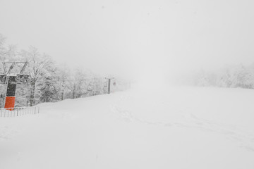 Fototapeta premium Ski lift over snow mountain in ski resort .