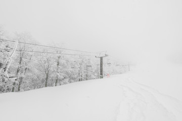 Ski lift over snow mountain in ski resort .