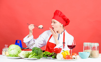 Girl at kitchen table. Cooking food and housekeeping. Housewife routine. Professional cooking tips. Woman chef try taste eat food. Delicious recipe concept. Cooking meal. Cooking healthy food