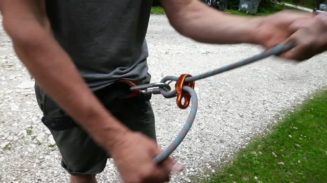 Human hands with assistance equipment for rock climbing