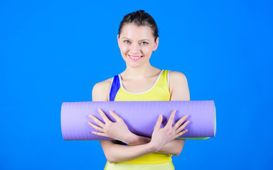 Practicing yoga every day. Girl smiling slim fit athlete hold fitness mat. Fitness and stretching....