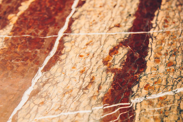 Texture of red and white marble stone close up. close-up layered rock structure