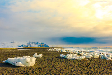Ice cube breaking on black rock beach , Iceland winter season landscape