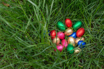 Easter egg hunt: chocolate eggs in a nest of grass