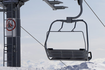 Ropeway on ski resort in high mountains at winter evening