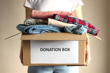 girl holding a box with donations