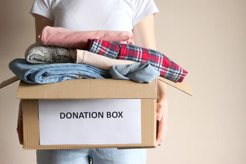 girl holding a box with donations