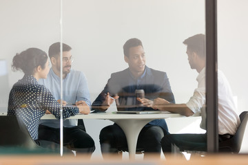 Diverse business people brainstorm at briefing in office
