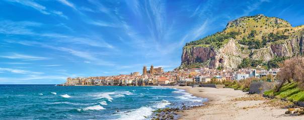Long sandy beach and blue sea in Cefalu, Sicily, Italy