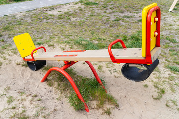 Empty wooden colorful seesaw board on playground. - 270773944