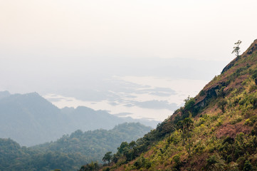 Foggy mountain landscape in autumn in Khao Laem National Park in Kanchanaburi province of Thailand.