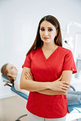 Obraz premium Portrait of female dentist. She standing at her office