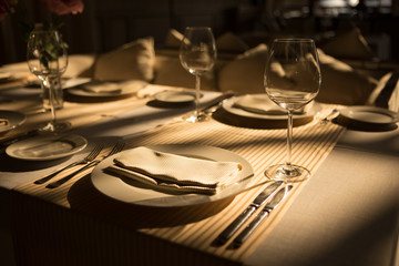Table setting for a wedding ceremony at swimming pool. round table with white tablecloth