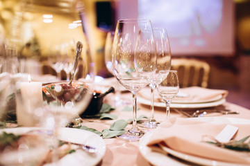 Table setting for a wedding ceremony at swimming pool. round table with white tablecloth