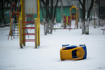 Playground covered with snow. Yard playground in the winter.