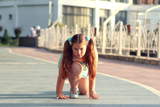 teen girl with overweight in start position on track. childhood obesity