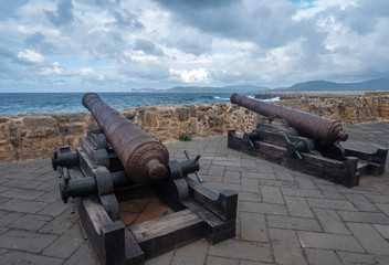 Ancient canons facing the Alghero bay (L'Alguer), province of Sassari , Sardinia, Italy.