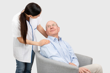 Smiling nurse and old senior man patient
