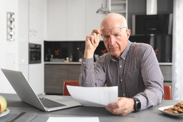Senior man worried about bills and savings