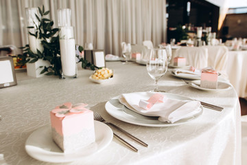 Table setting for a wedding ceremony at swimming pool. round table with white tablecloth