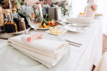 Table setting for a wedding ceremony at swimming pool. round table with white tablecloth