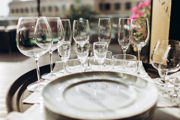 Table setting for a wedding ceremony at swimming pool. round table with white tablecloth