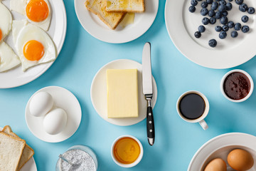 top view of served breakfast on blue background