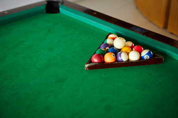 Billiards balls on green table 