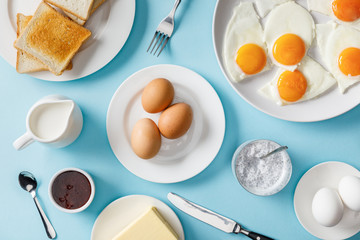 top view of breakfast with yogurt on blue background