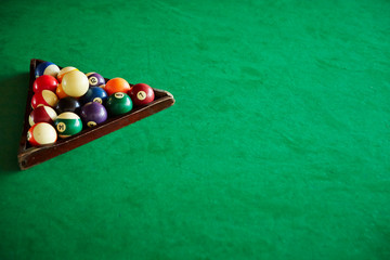 Billiards balls on green table