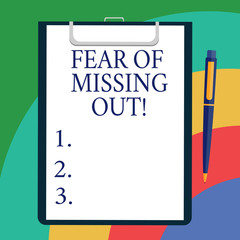 Conceptual hand writing showing Fear Of Missing Out. Business photo showcasing Afraid of losing something or someone stressed Sheet of Bond Paper on Clipboard with Ballpoint Text Space