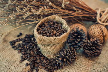 Roasted coffee beans in a sack on dark background