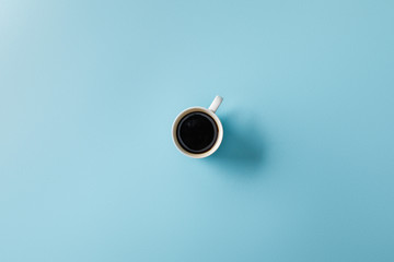 top view of coffee in cup on blue background