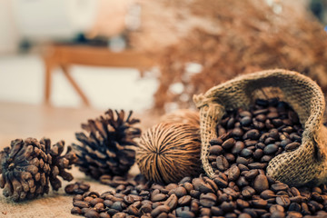 Roasted coffee beans in a sack on dark background