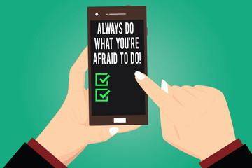 Handwriting text writing Always Do What You Re Afraid To Do. Concept meaning Overcome your fear Challenge motivation Hu analysis Hands Holding Pointing Touching Smartphone Blank Color Screen
