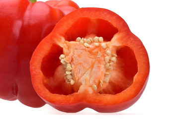 Bulgarian red pepper, cut in half with white seeds inside on a neutral white background