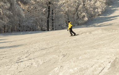 ASHA, RUSSIA - 27 april 2011: snowboarder descends on snow-covered slope and makes a turning...