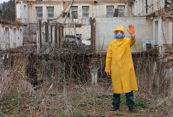 Man with protective  mask and protective clothes explores danger area.