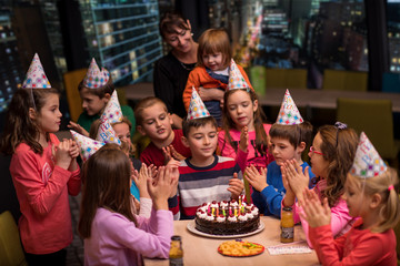 happy young boy having birthday party