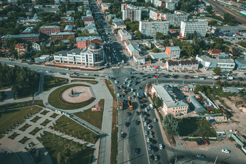 Aerial view of city traffic intersection with cars