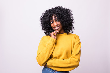 Portrait of beautiful young african woman holding her chin, trying to find best solution. Body...