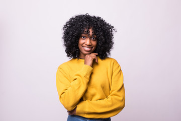 Portrait of beautiful young african woman holding her chin, trying to find best solution. Body...