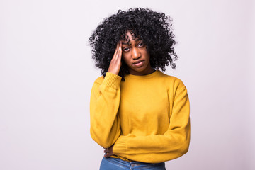 Constrained young african woman closing eyes tight and massaging temples with fingers to soothe unbearable migraine. Forgetful girl squeezing head with hands, trying hard to recollect something