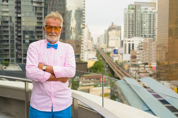 Handsome senior tourist man exploring the city of Bangkok, Thail