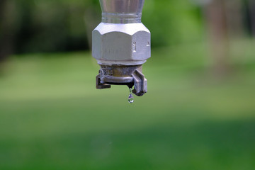 dripping faucet or fountain in front of blurred background